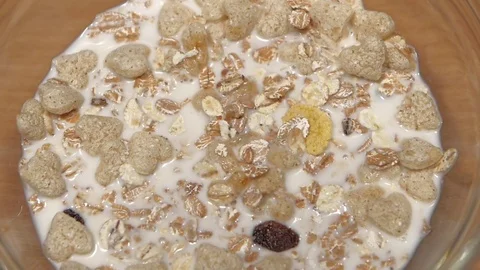 Syrup is added to plate with dry breakfast. Slow motion Stock-Footage 76131624