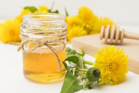 Syrup, dandelion honey, composition with fresh flowers Stock Photos