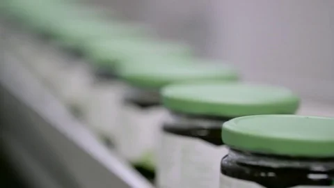 Syrup jars on a production line Stock Footage 82076778