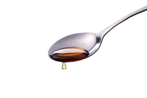 Syrup on a spoon Stock Photos