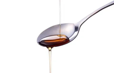 Syrup on a spoon Stock Photos