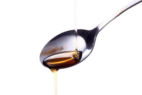 Syrup on a spoon Stock Photos