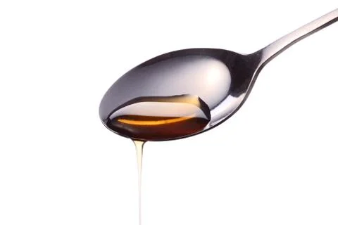 Syrup on a spoon Stock Photos