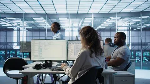 System admin working in diverse computer network security data center Stock Photos