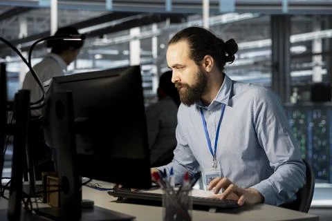 System administrator in data center doing software updates Stock Photos