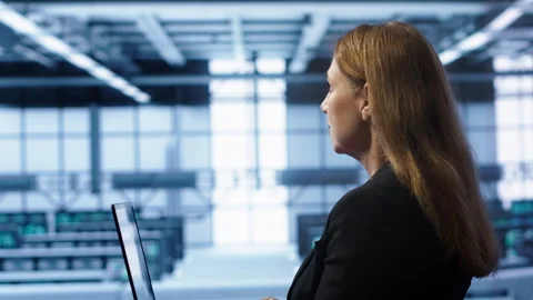 System administrator in data center running error checking utilities on laptop Stock Footage 277646946