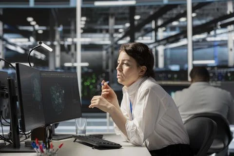 System administrator in data center using AI powered tech to run simulations Stock Photos