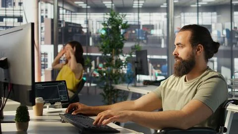 System administrator with disability training machine learning models Stock Photos