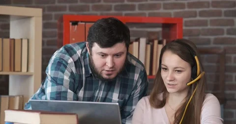 System administrator explains girl manager how to connect computer to wi-fi Stock Footage 131095763