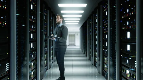 System Administrator Man With A Tablet In A Futuristic High Tech Server Room Stock Footage 238482379