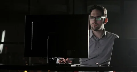 System administrator man is working in the office late at night overtime. Stock Footage 105301564