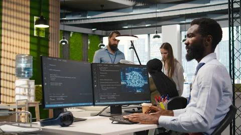 System administrator in office using PC, automating repetitive tasks with AI 스톡 사진