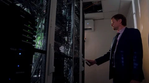 The system administrator opens the cabinet with computers in the server Stock Footage 128549168