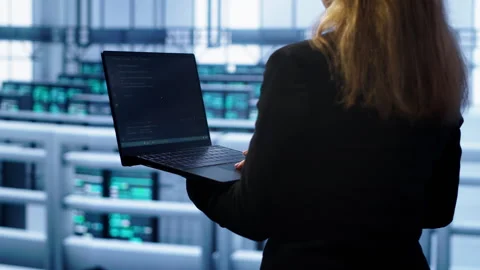 System administrator in server farm using laptop to patch network issues Video stock 277645031