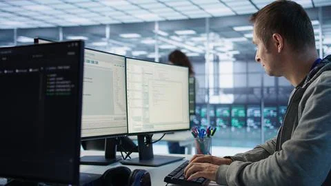 System administrator in server room doing system analysis, coding Stock-Fotos