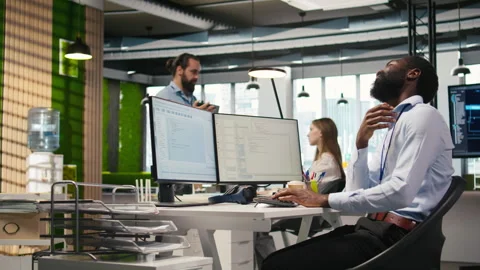 System administrator in tech startup office using PC, troubleshooting hardware Stock Footage 313017078