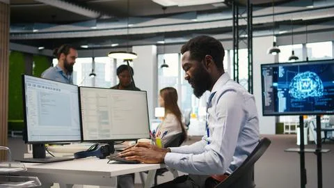 System administrator in tech startup office using PC, troubleshooting hardware Stock Photos