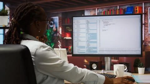 System administrator types code into PC, developing software Stockfoto's