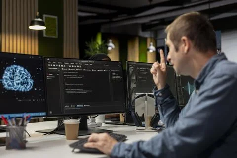 System administrator using AI in tech startup office to develop programs Foto stock
