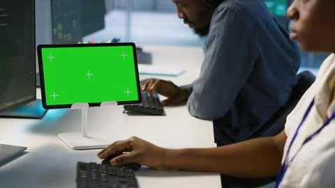 System administrator using isolated screen tablet, working in server farm Stock Photos