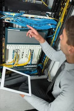  The system administrator works in the server room Young man is standing n... Foto stock