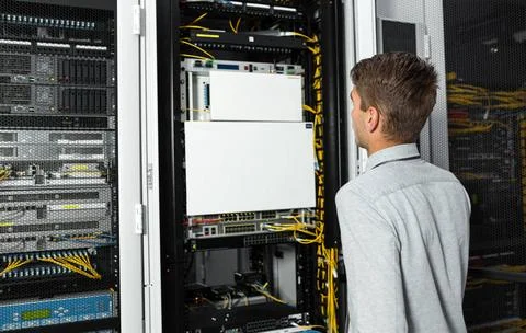  The system administrator works in the server room Young man is standing n... 스톡 사진