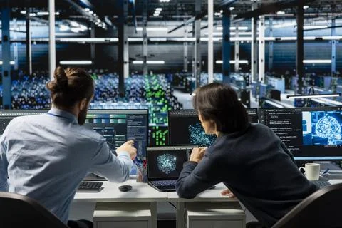 System administrators coding in data center, updating AI automation scripts Stock Photos