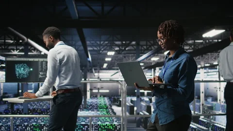 System administrators on data center platform analyzing performance outputs Stock Footage 310783704