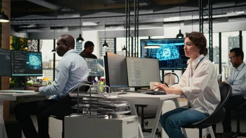 System administrators in office automate workflows using artificial intelligence Stock Footage 323032646