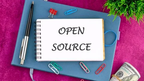 System and website builder concept. OPEN SOURCE in a mini notebook on a busin Stock Photos