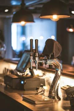 The system of bottling beer on the table of customers in the brewery. Stock Photos