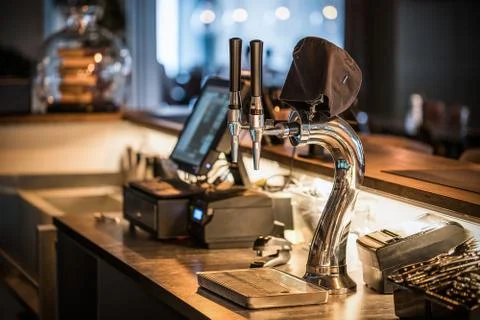 The system of bottling beer on the table of customers in the brewery. Stock Photos
