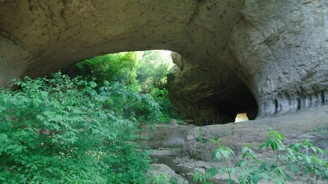 SYstem of caves and a rocky bridge formation Stock Footage 89604824
