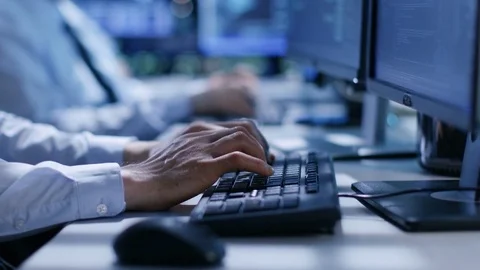 In the System Control Center Team of Technicians Monitor System Stability.  Stock Footage