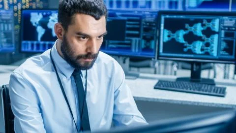 In the System Control Center Technical Operator Monitors Displays at His Work Stock Photos