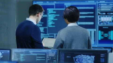 In the System Control Room IT Specialist and Project Engineer Have Discussion. Stock Footage 80982297