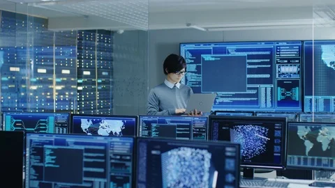 In the System Control Room IT Technician Holds and Works on a Laptop. Stock Footage 80979703