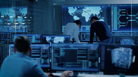 In the System Control Room Project Manager and IT Administrator Have Discussion Stock Footage