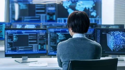 In the System Control Room Technical Operator Works at His Workstation with M Stock Photos