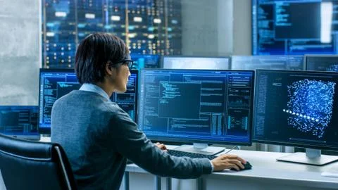 In the System Control Room Technical Operator Works at His Workstation with M Stock Photos