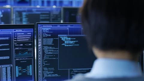 In the System Control Room Technical Operator Stands and Monitors Various Act 写真素材