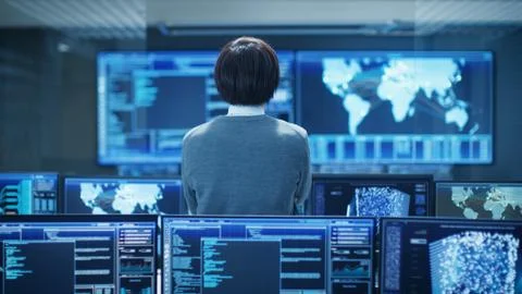In the System Control Room Technical Operator Stands and Monitors Various Act Stock Photos