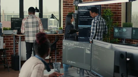 System developers analyzing code on wall screen tv looking for errors Stock Footage 168250562