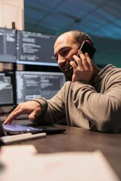System engineer answering phone call late Stock Photos