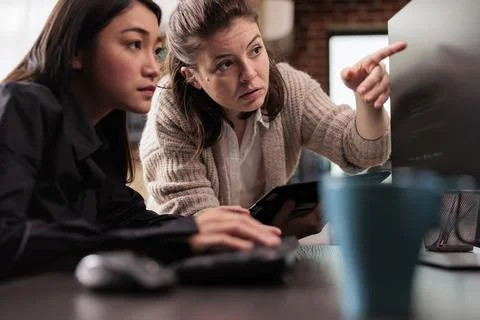 System engineers collaborating on coding project Stock Photos