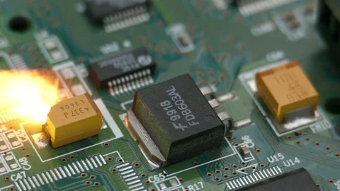 System overload concept. The tantalum capacitor on the chip explodes. Video stock 243004708