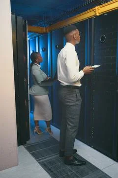 The system shouldnt be running at this pace. Full length shot of two young IT Stock Photos