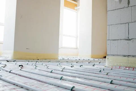 System of underfloor heating, work in progress on a construction site for a f Stock Photos