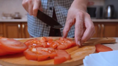 Systematically dicing tomatoes with sharp blade for fresh salad dish Stock Footage 329062684