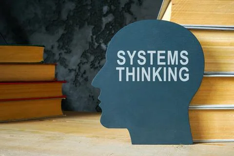 Systems thinking sign on the head shape and books. Stock Photos